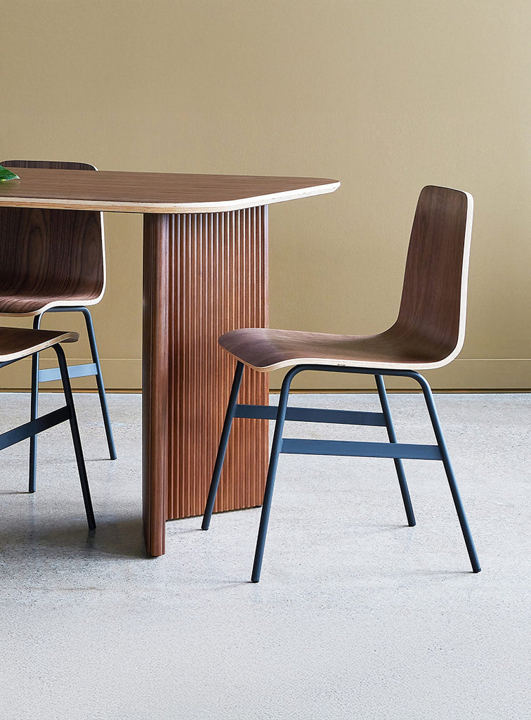 Gus* Modern Lecture Dining Chair in a styled room setting