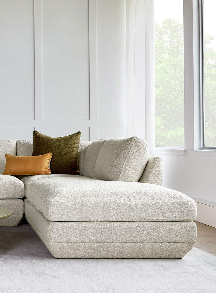 Gus* Modern Podium Ottoman in a styled room setting