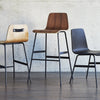 Gus* Modern Lecture Barstool Wood in a styled room setting