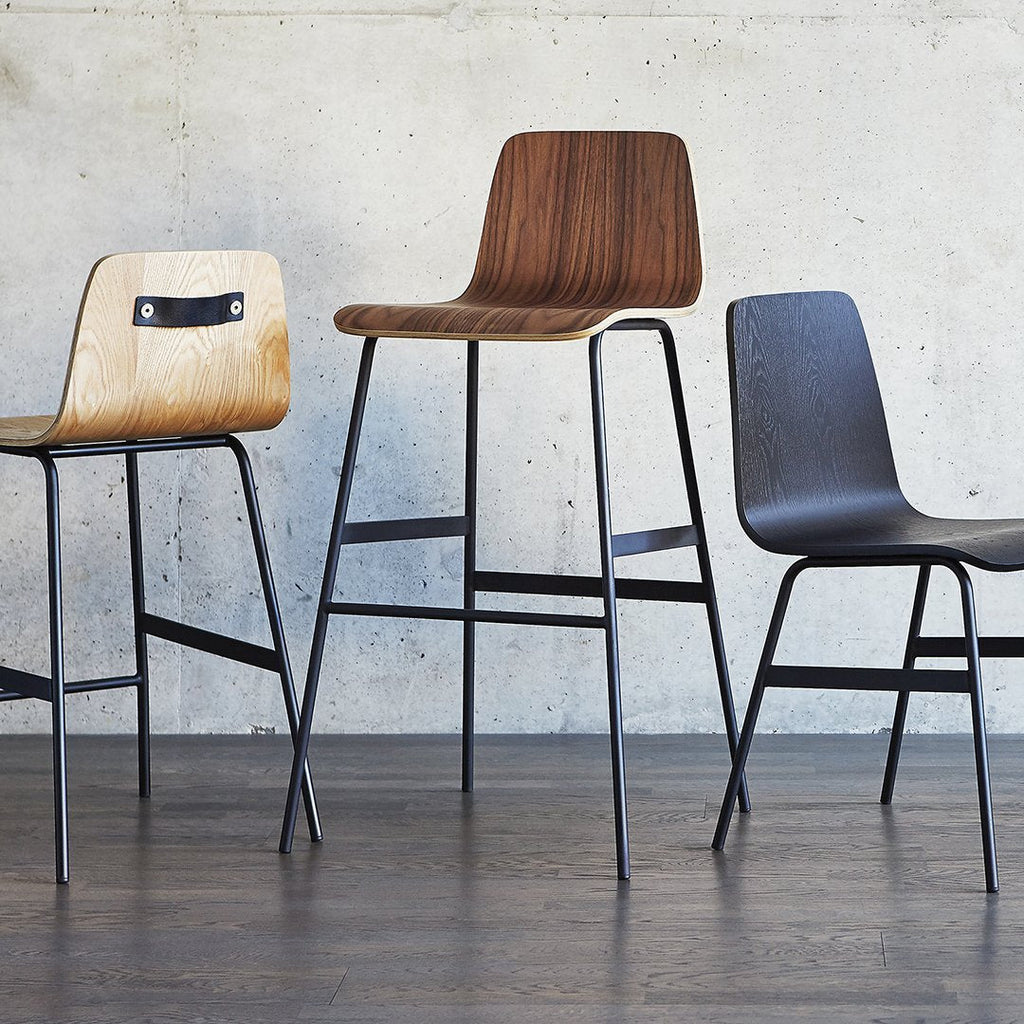 Gus* Modern Lecture Barstool Wood in a styled room setting